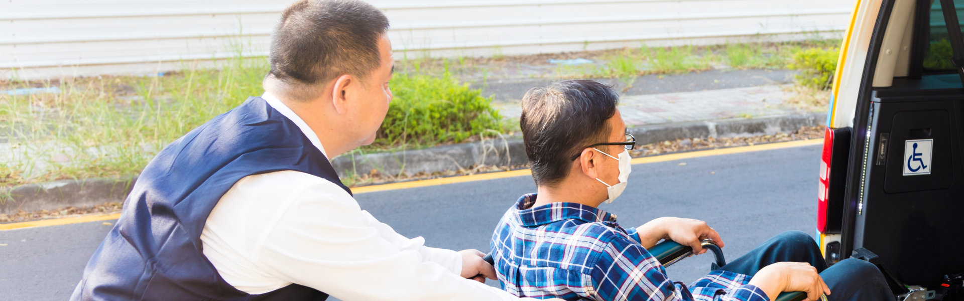 Medical staff pushing the man sitting on the wheel chair